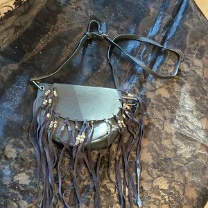 Black leather fringed purse with silver beads.